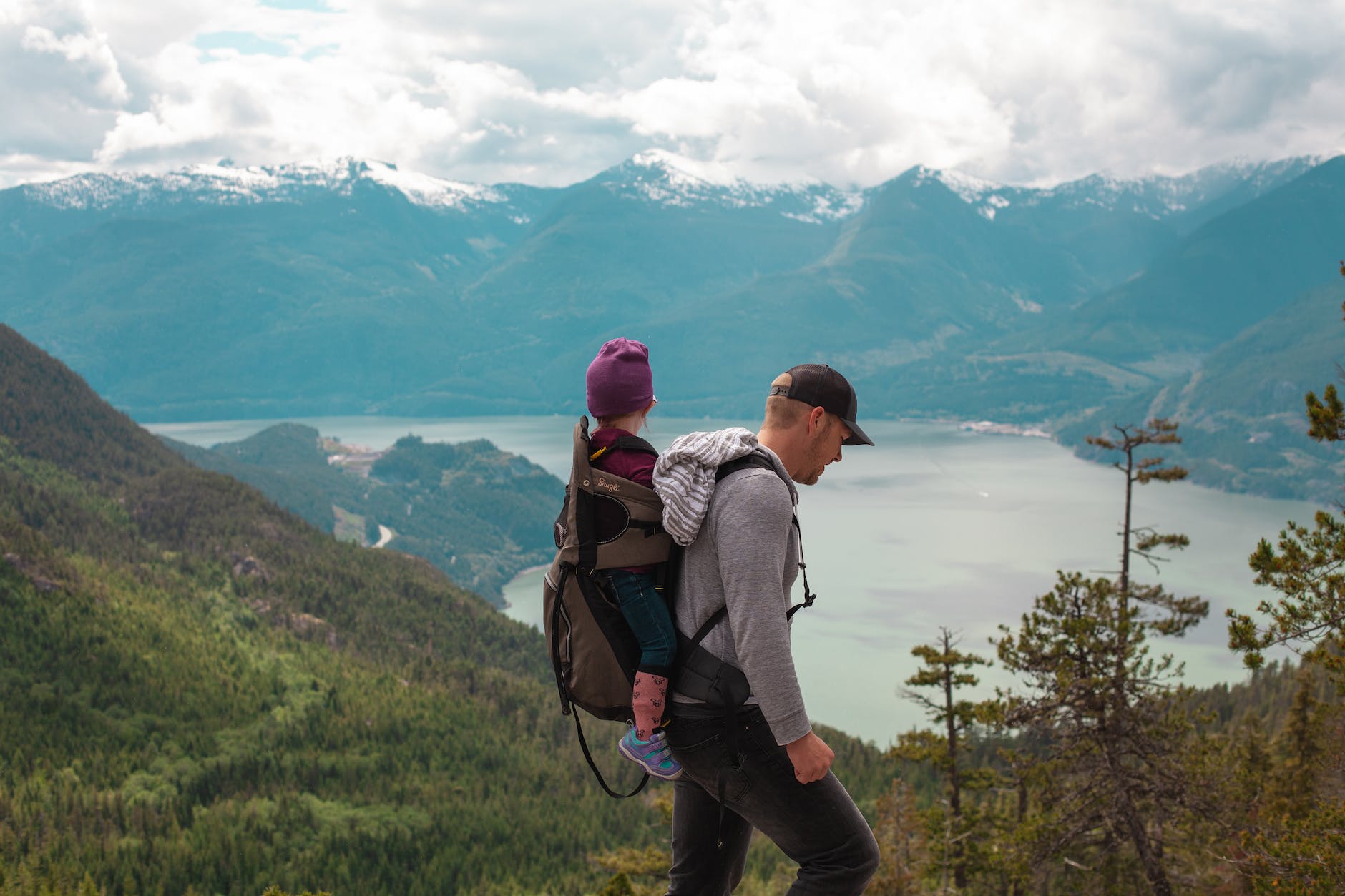father and child hiking in a mountain landscape